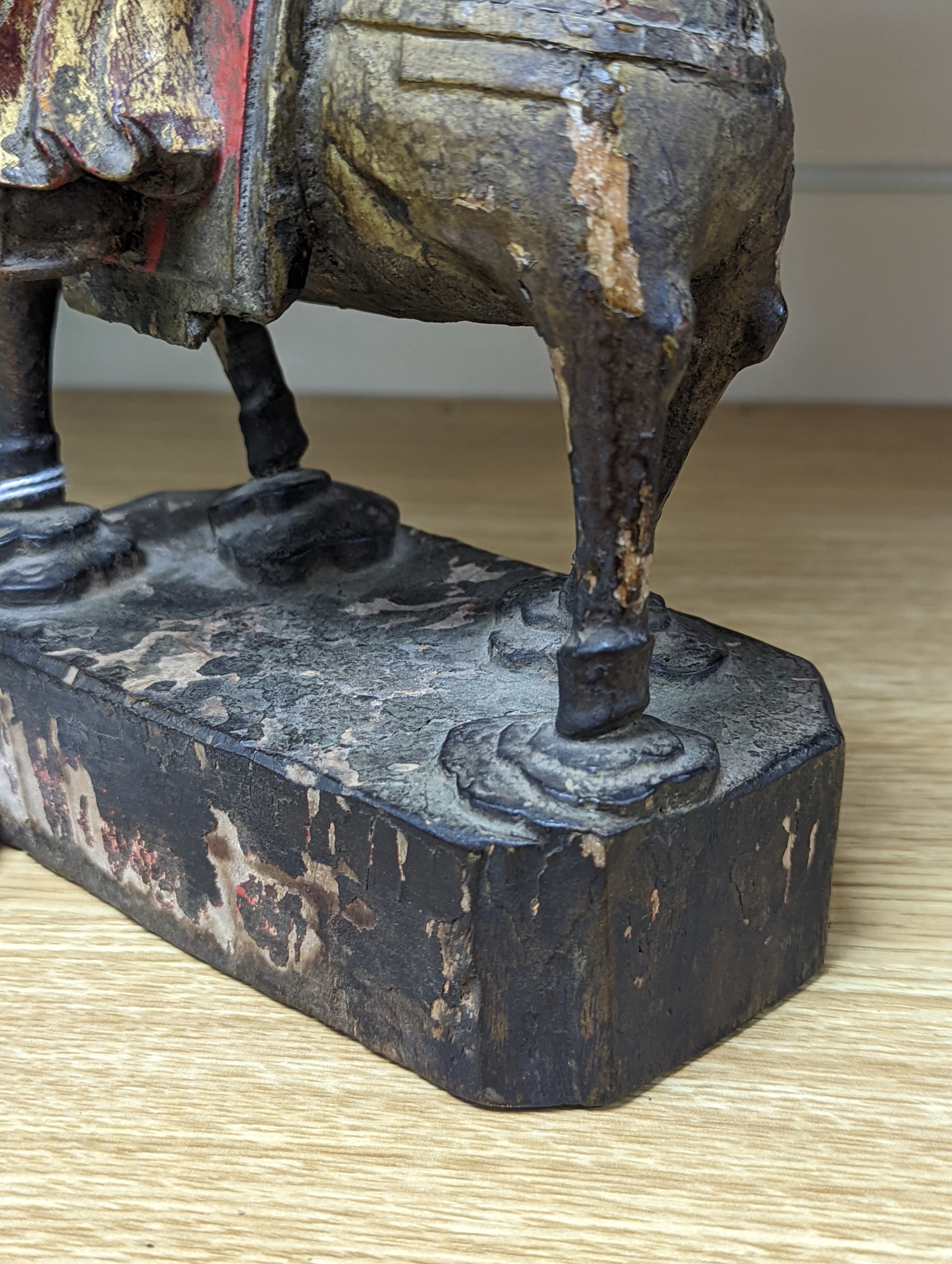 An 18th/19th century Chinese lacquered wood group of an official riding a horse, 30cm